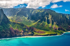 A coastal landscape with steep cliffs and a beach.