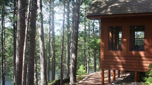 A cabin with a wooden exterior, a window, and a door.