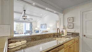 A kitchen with granite countertops, a dishwasher, and wooden cabinets.