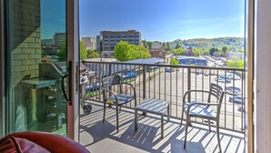 A balcony with a view of a parking lot and buildings. - Balcony Condo in Downtown Asheville (Asheville)