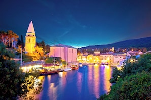 A waterfront town with a prominent tower and buildings along the river.