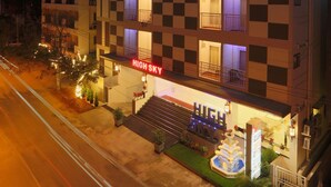 A multi-story hotel with a checkered facade, balconies, and a prominent 'HIGH SKY' sign. - High Sky Krishna Global Villaments (Bengaluru)