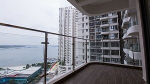 A balcony with a view of a high-rise building and a marina. - JAgape (Johor Bahru)