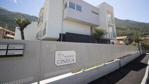 En modern byggnad i två våningar med en skylt som visar texten ”RESIDENZA CINISCA”.