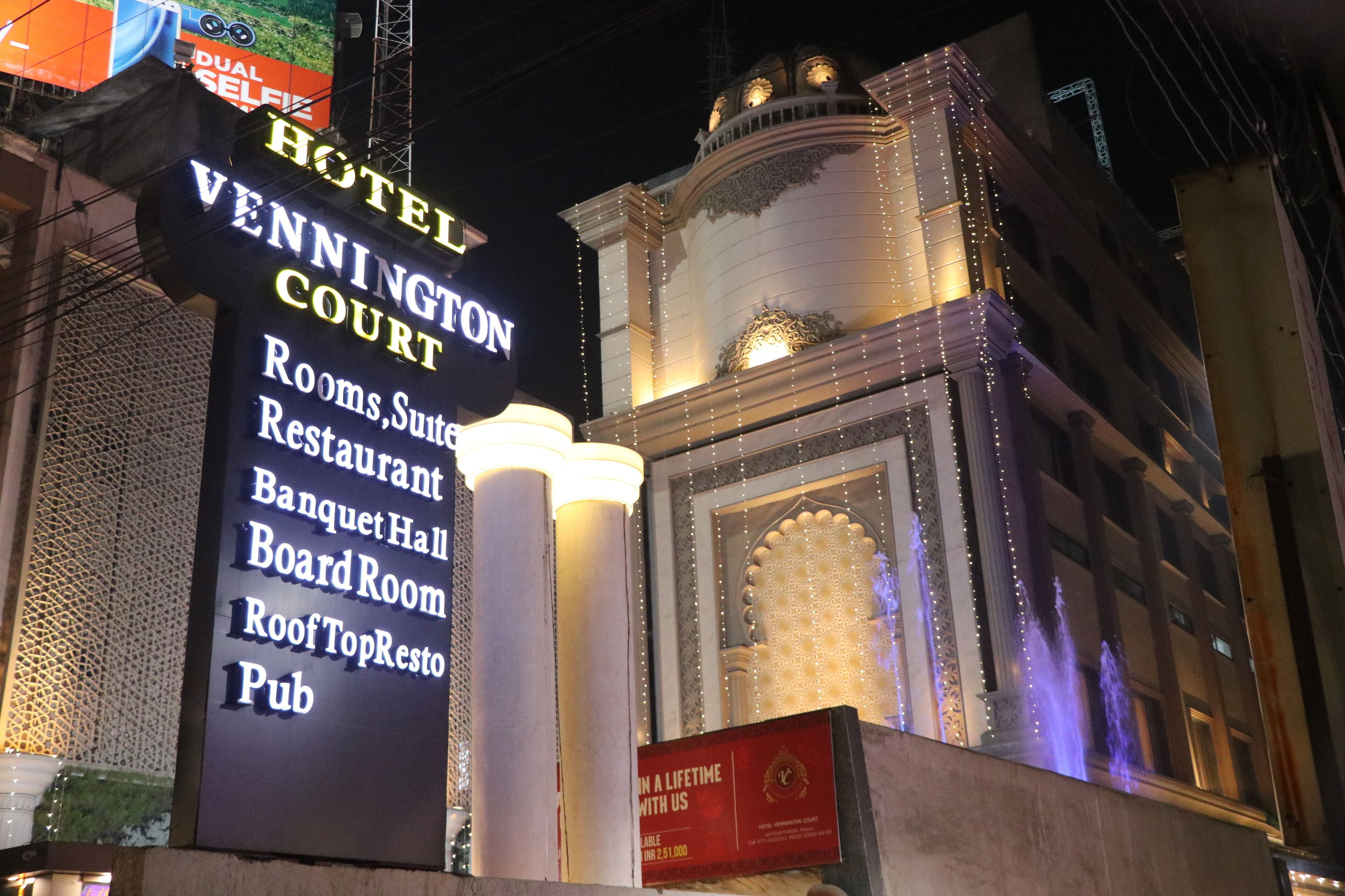 A hotel sign with amenities including rooms, suites, restaurant, banquet hall, board room, roof top resto, and pub.