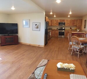 Living room, dining room kitchen with 60inch, gas stove, microwave, dishwasher