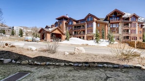 A large, multi-story lodge with a rustic architectural style, featuring balconies and large windows. - Deluxe, Classic Mountain Condo | Near Chairlifts (Crested Butte)