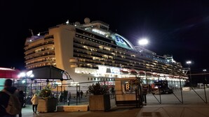 A large cruise ship docked at a port with multiple decks and balconies, illuminated by artificial lighting. - HOV B&B House -Hospitality Ocean view Victoria- (Victoria)