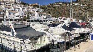A marina with boats docked, a clear sky, and buildings in the background. - Casa Valderrama - Beautiful Spacious Villa With Private Pool And Hot Tub.  (La Herradura)