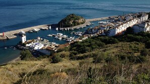 A coastal town with a marina, white buildings, and a prominent hill with greenery. - Casa Valderrama - Beautiful Spacious Villa With Private Pool And Hot Tub.  (La Herradura)