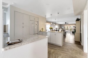 Enjoy cooking in this well-equipped kitchen with a central island, ample counter space, and integrated appliances.