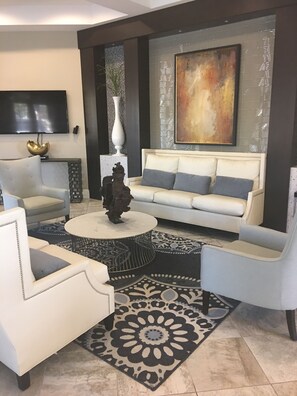 Relax in this stylish living area with a sofa, armchair, and flat-screen TV.