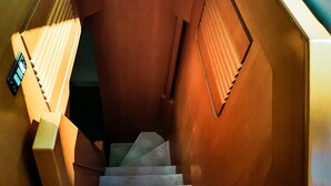 A staircase with a wooden finish and a handrail on the right side. - Yacht Diva (Venice)
