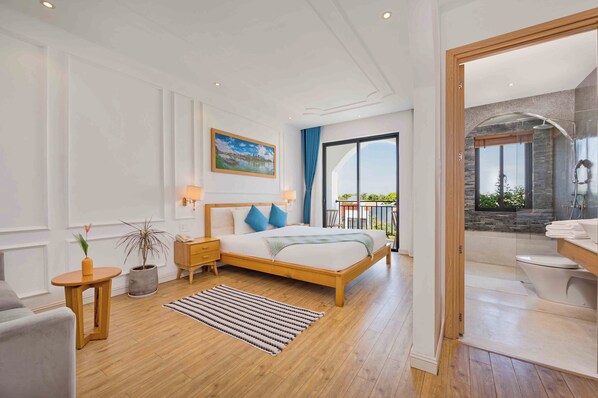 A modern bedroom with a wooden bed, a nightstand, a potted plant, a painting, and a view of the balcony.