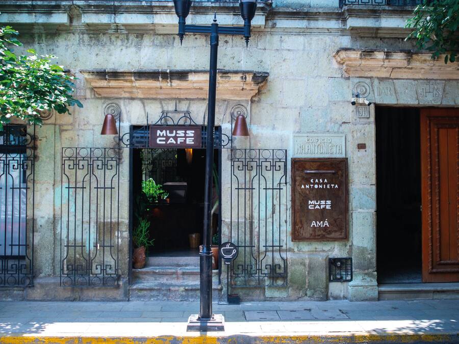 A building facade with a sign reading "Muss Cafe" and "Casa Antonieta".
