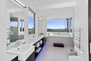Bathtub, hair dryer, towels, shampoo