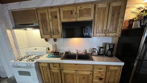 A kitchen with wooden cabinets, a stove, a sink, and a refrigerator. - SPACIOUS  ONE  BEDROOM APARTMENT VERY CLOSE TO VENICE BEACH with washer /dryer (Los Angeles)