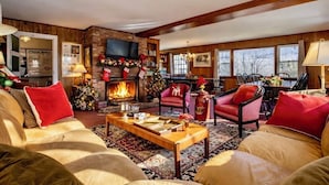 A cozy living room with a fireplace, comfortable seating, and holiday decorations. - Perfect Reunion House for 18! 8 bedrooms, 5 baths, Pool, Tennis, Big lawn, Dogs! (Manchester)