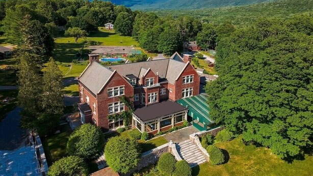 A large, multi-story brick building with a swimming pool, surrounded by lush greenery and hills. - Perfect Reunion House for 18! 8 bedrooms, 5 baths, Pool, Tennis, Big lawn, Dogs! (Manchester)