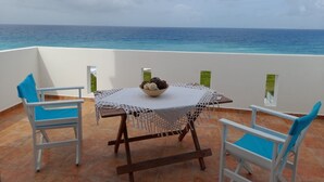 A terrace with a table and chairs, overlooking the sea. - Charming Waterfront Villa in South Rhodes , near Monolithos and Prasonissi (Apolakkia)