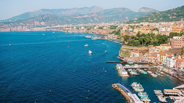 A coastal town with a marina, boats, and buildings along the waterfront. - Casa Chicco - My Rental Homes (Sorrento)