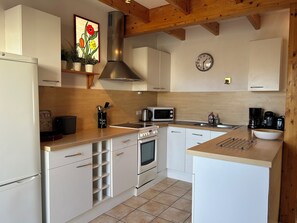 A modern kitchen with white cabinets, a stainless steel range hood, a microwave, and a coffee maker. - Lovely, quiet house*** 800 m from Kerlouan beach. (Kerlouan)