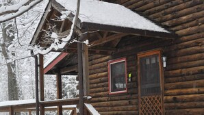 A wooden cabin with a covered porch and steps leading to the entrance. - Stay WATERFRONT. Stay CHEAT RIVER LODGE (Elkins)
