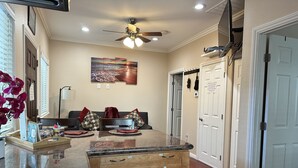 A modern kitchen with a central island, wooden cabinets, and a ceiling fan. - High end 1BR/1BA Attached House in the Heart of Silicon Valley, Non-Smokers only (San Jose)