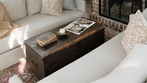 A cozy living room with a fireplace, a sofa, and a coffee table. - Modern Cabin By Bear Lake (Cookeville)
