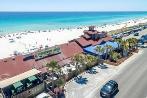 A beachfront property with a prominent seafood restaurant sign, a parking area, and a view of the beach. - Discounts Summer Very Short Walk to Beach - 2BD/2BA Sleeps 6 (Miramar Beach)