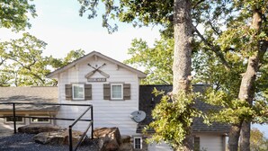 A white building with a sign reading "Hideaway" and a satellite dish. - Hideaway at CrossTimbers Marina (Sperry)