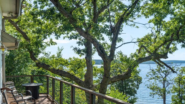 A deck with outdoor furniture overlooking a lake. - Hideaway at CrossTimbers Marina (Sperry)
