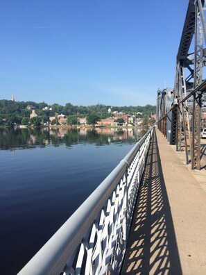 A bridge with a metal railing and a calm body of water below. - Stillwater's Third Street Inn (Stillwater)