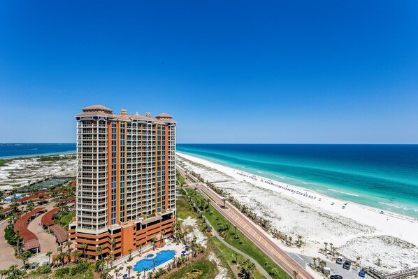 A high-rise hotel with a pool and beach view. - P5-1809 Welcome to our Coastal Getaway at Portofino! (Pensacola Beach)