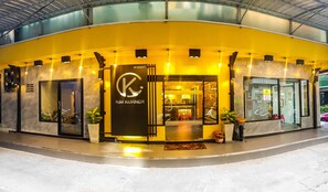 A modern building with a prominent 'Kim Korrner' sign, featuring a sleek entrance and a glass facade. - Kim Korner Hotel (Bangkok)