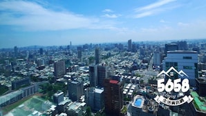 A cityscape with high-rise buildings, a clear sky, and a logo with the number 5658. - 85 Eagle Hotel (Kaohsiung)