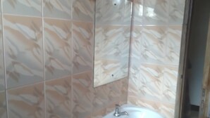 A bathroom with a white sink and a mirror mounted on the wall. - Tengoz Lodge (Morogoro)