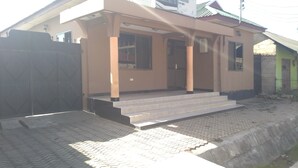 A building with a signboard advertising a bed and breakfast. - Tengoz Lodge (Morogoro)