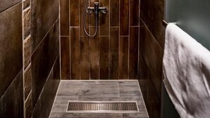 A small, tiled shower area with a handheld showerhead and a wall-mounted faucet. - Beauty Avenue Inn (Kaohsiung)