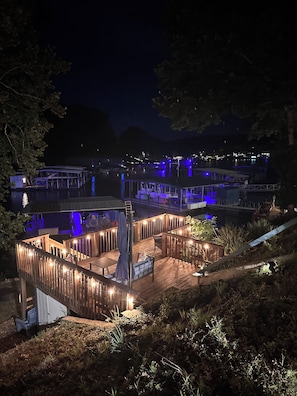 Enjoy waterfront views from the deck with seating and a table.