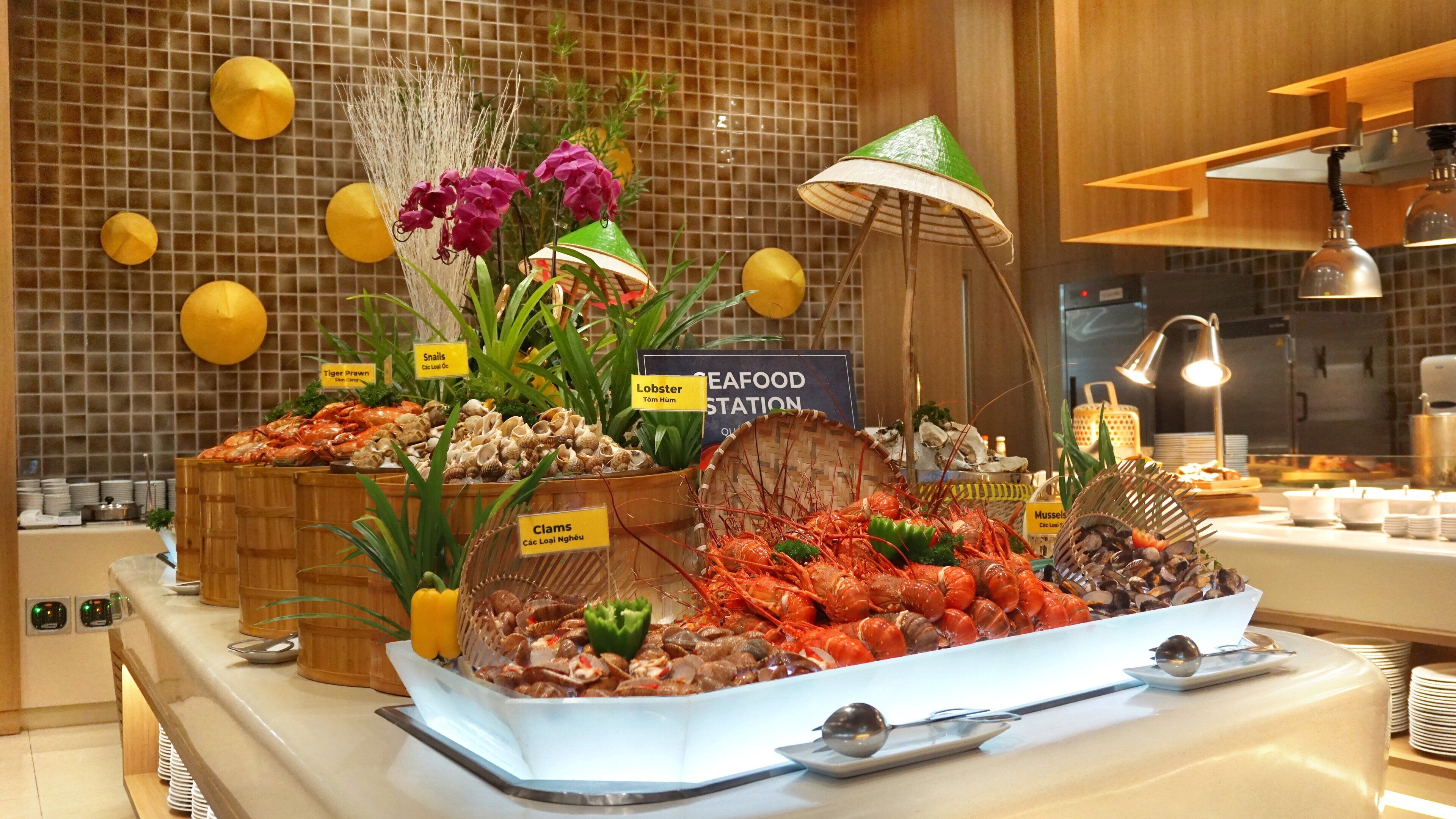 A seafood station with various types of seafood displayed, including lobsters, clams, and snails.