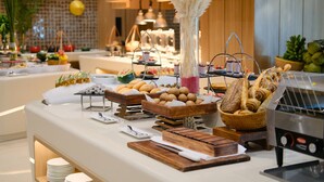 Een buffet met diverse gerechten en een koffieapparaat.