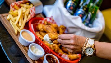 A tray with fried chicken, French fries, and dipping sauces.
