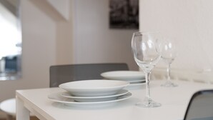 A dining table with white plates and wine glasses, a chair, and a framed picture on the wall. - Kirkstall House (Leeds)