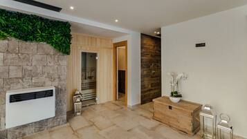 A modern interior with a stone wall, a wooden cabinet, and a potted plant.