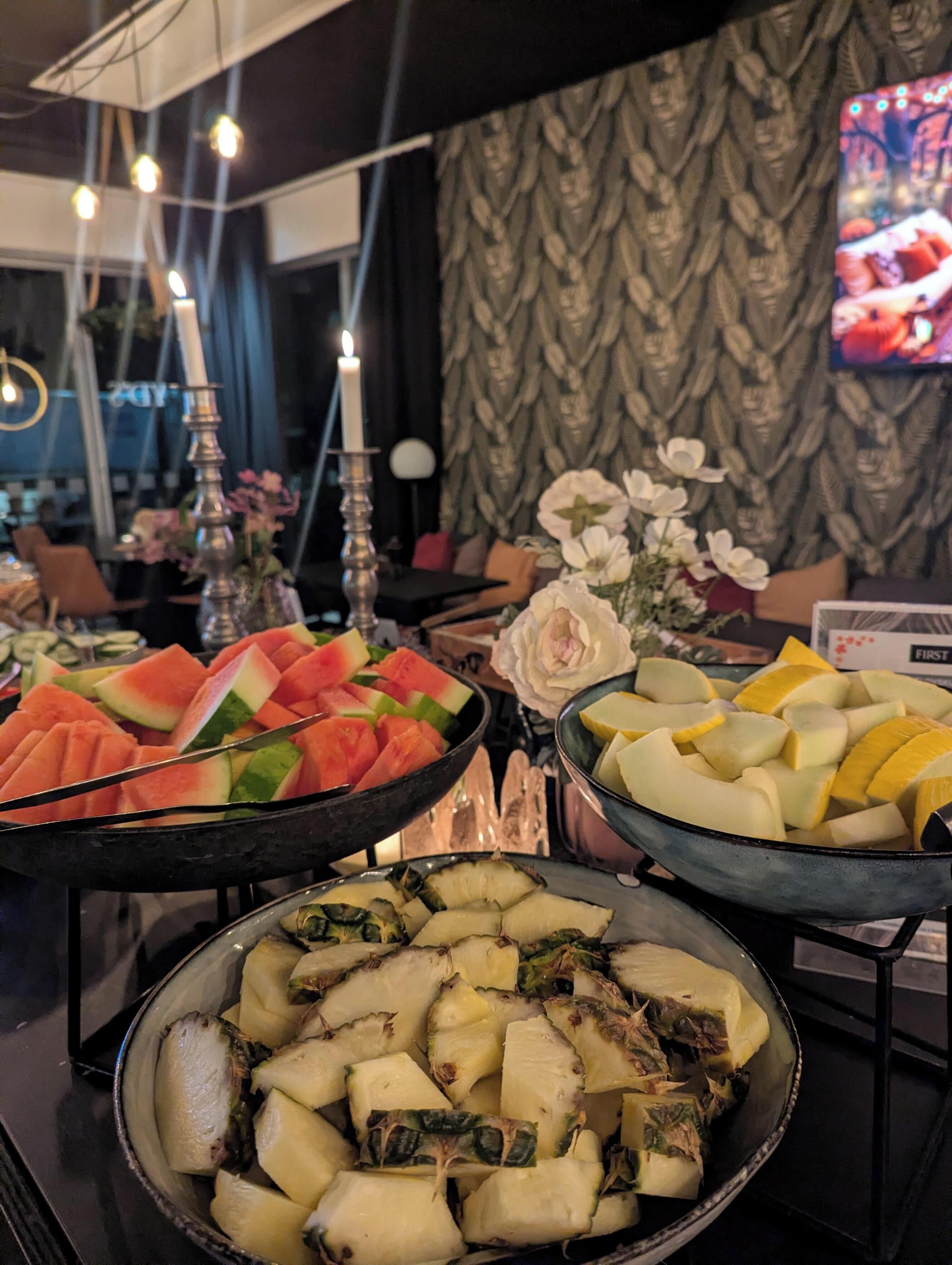 A buffet with various fruits and vegetables.