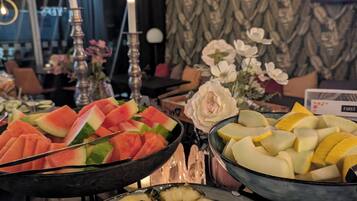 A buffet with various fruits and vegetables.