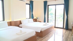 A hotel room with two beds, a balcony, and a view of greenery. - Hoang Kim Hotel (Vientiane)