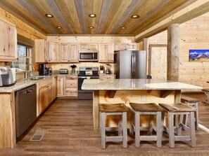 Enjoy cooking in this well-equipped kitchen with a large island and stainless steel appliances.