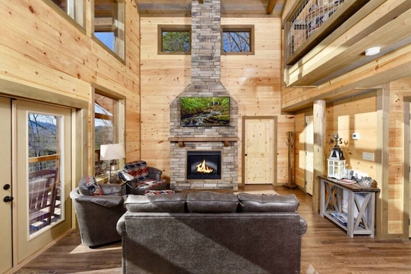 The main floor has a large 2 story great room with a massive fireplace and TV.